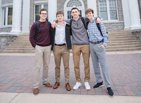 4 brothers in front of a library