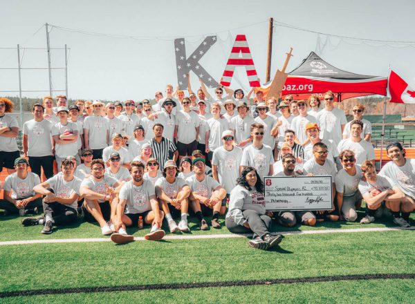 group of KA brothers on a football field