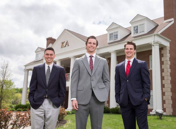 Members outside of a house with columns