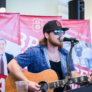 Hunter Chastain playing guitar and singing at Values Center