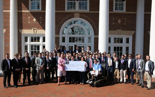 KA chapter members presenting check and track chair