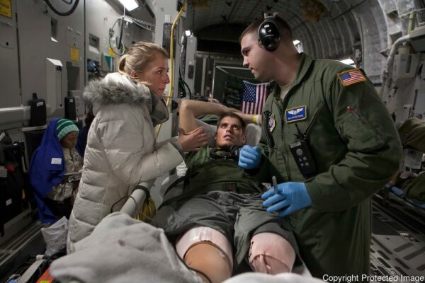 Laura Borneman, fiancee of marine 1st Lieutenant Patrick Glavey, talks with flight nurse Caleb Heder