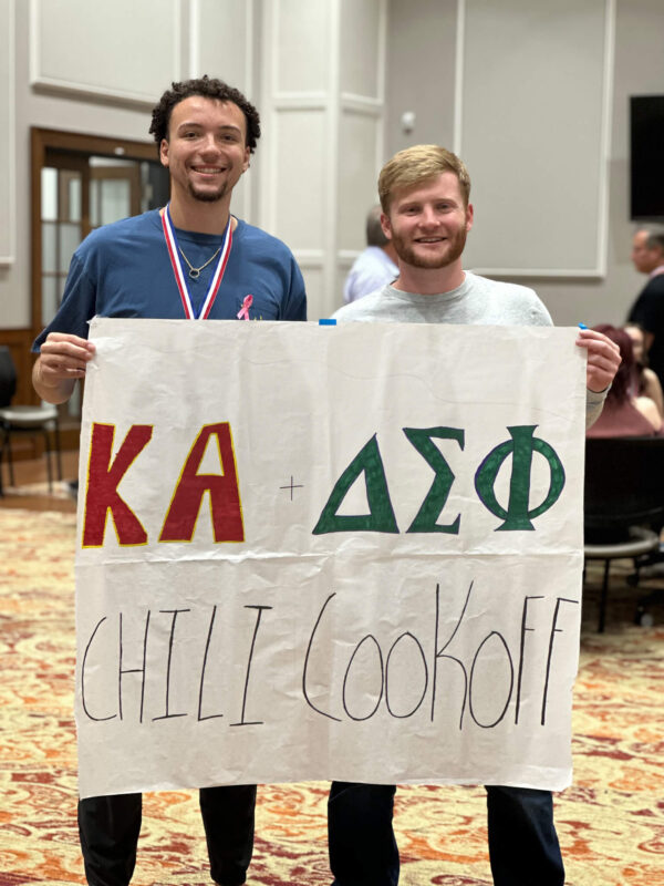 philanthropy chairs holding sign