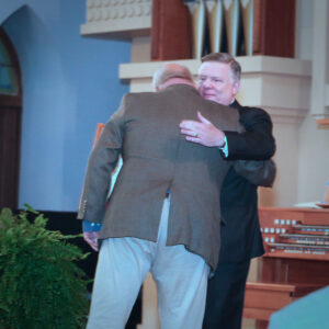 Knight Commander Aiken hugging Lee Oliver