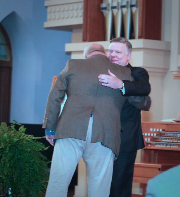 Knight Commander Aiken hugging Lee Oliver