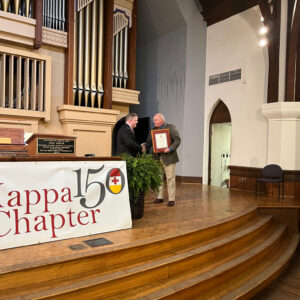 Lee Oliver with Knight Commander Aiken in front of Kappa 150 banner