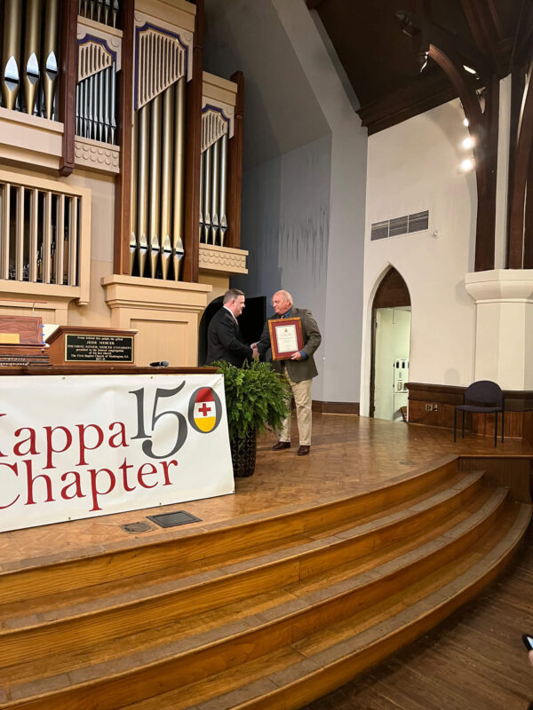 Lee Oliver with Knight Commander Aiken in front of Kappa 150 banner