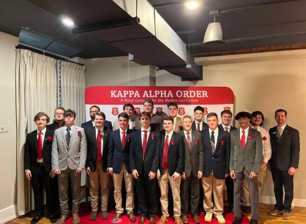 Group of men in front of Kappa Alpha Order backdrop