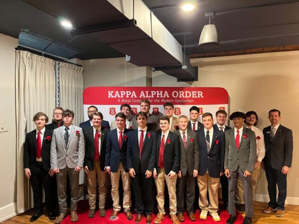 Group of men in front of Kappa Alpha Order backdrop