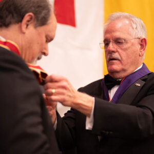 Former Knight Commander Duncan placing jewel on Dwain Knight