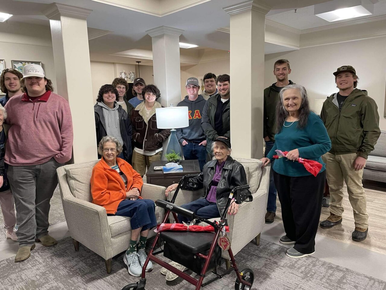 brothers with lady residents of senior center