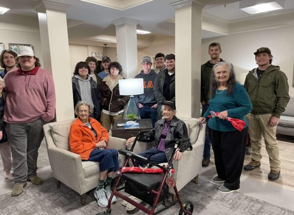 brothers with lady residents of senior center