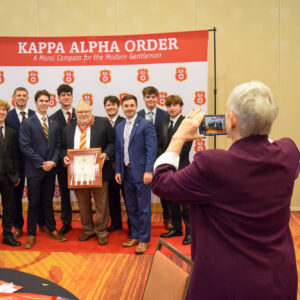 Tom Murray taking photo with Zeta Omicron Chapter