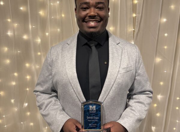 young man holding award