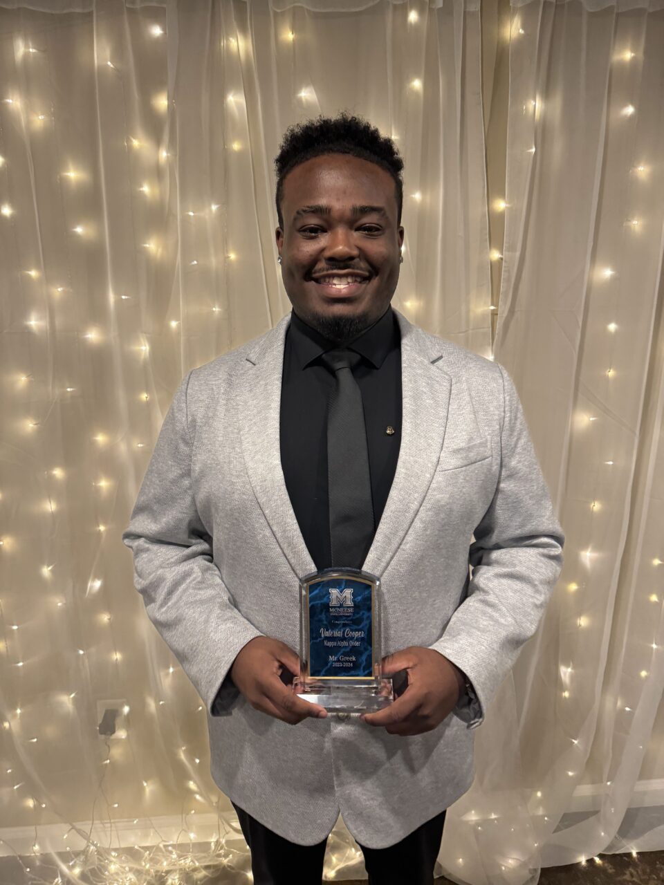 young man holding award