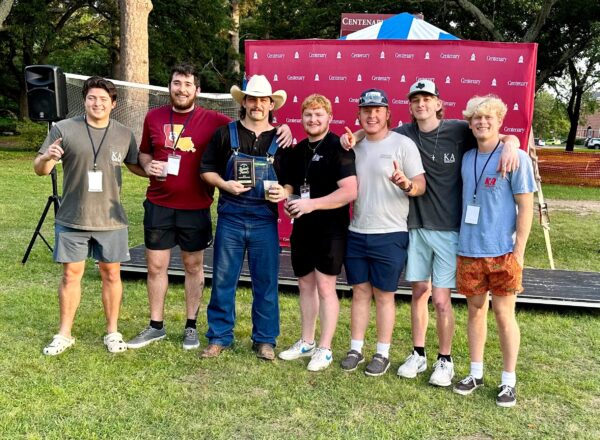 fraternity brothers standing in front of grill