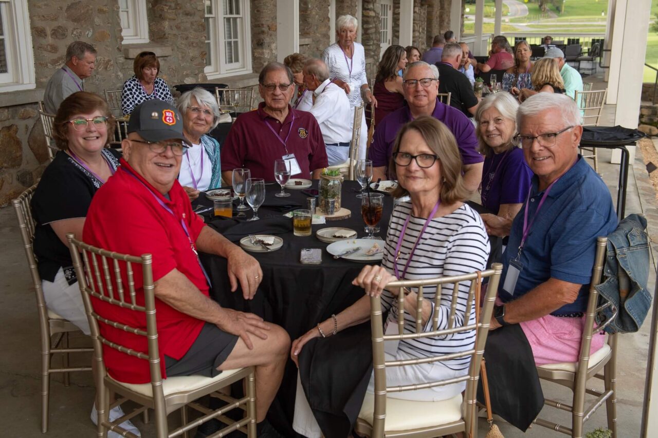 men and women around banquet tables