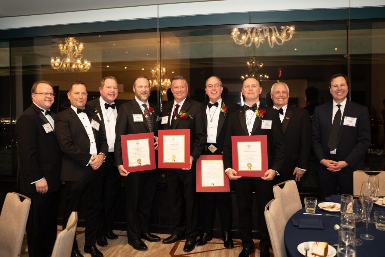 men in tuxes, four holding certificates