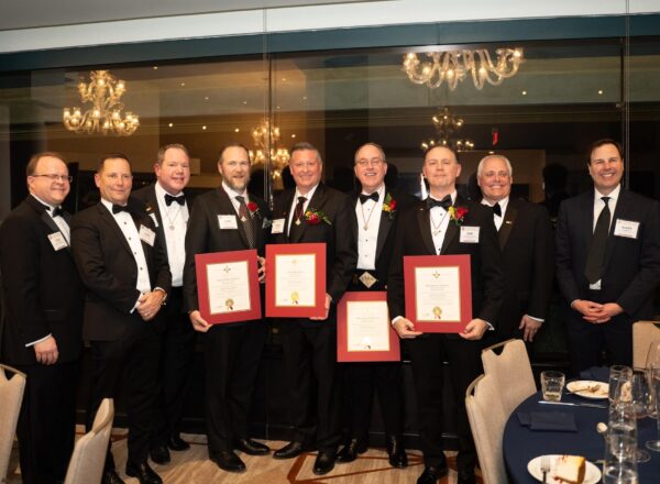 men in tuxes, four holding certificates