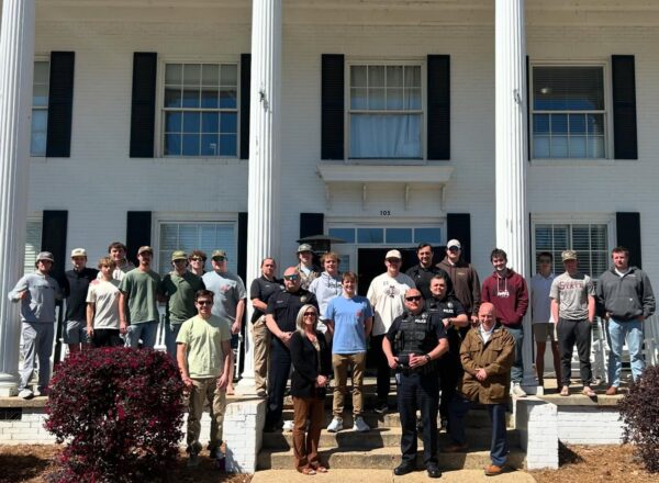 first responders and KA brothers on front porch of fraternity house