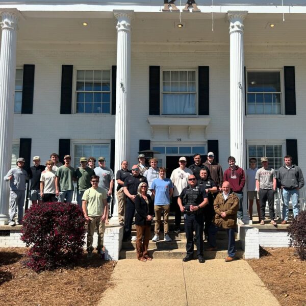 first responders and KA brothers on front porch of fraternity house