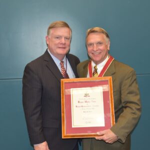 two men in suits holding award