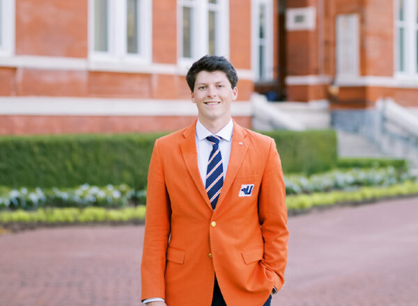 man in orange blazer and blue tie