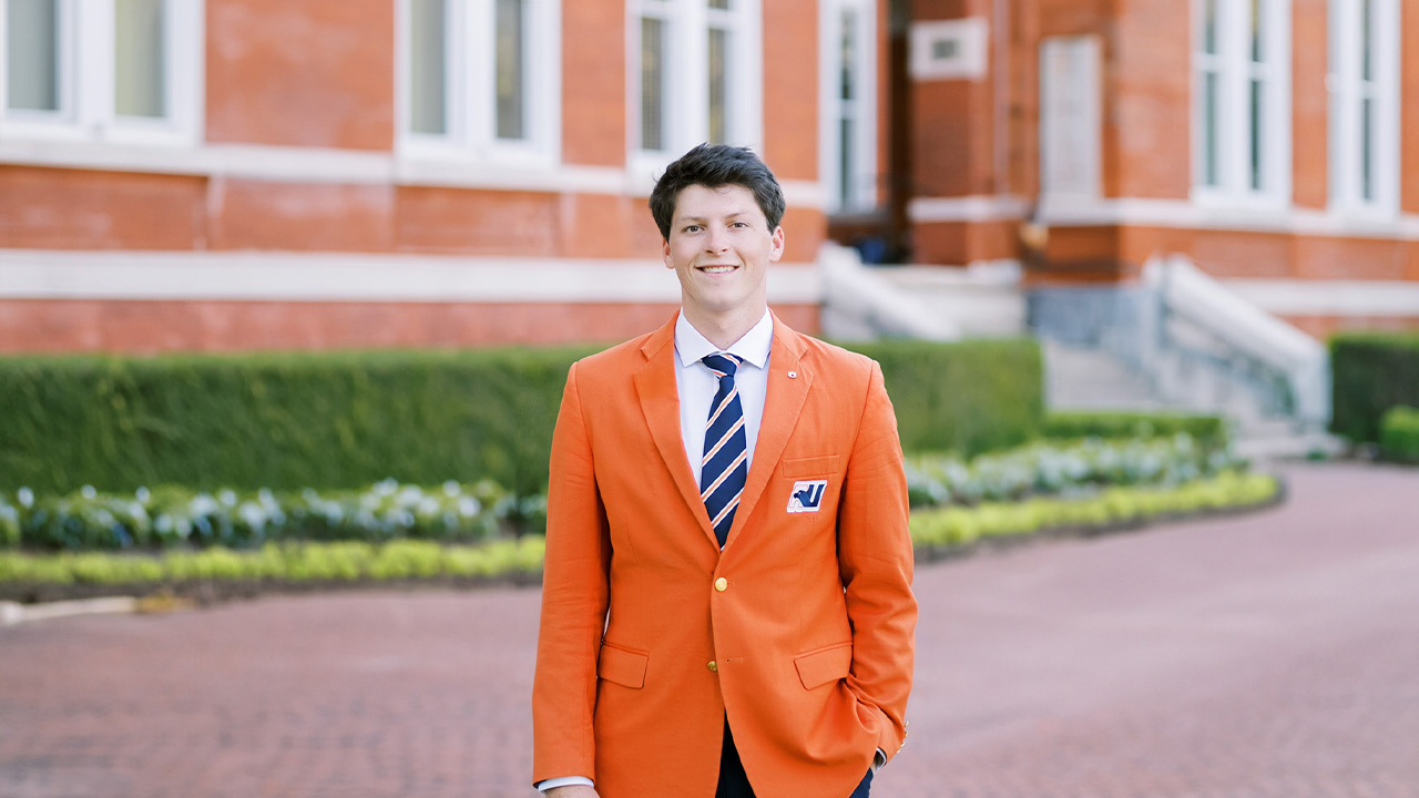 man in orange blazer and blue tie