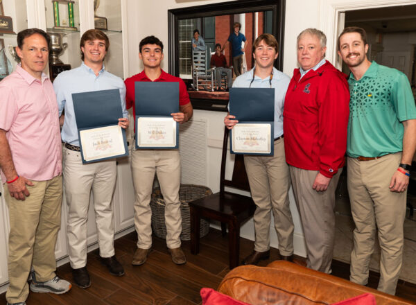 six men casually dressed, three with certificates