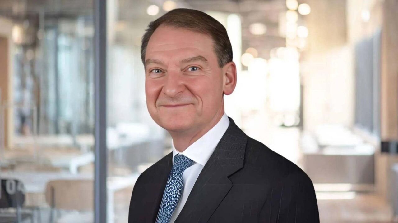 headshot of man in suit and tie