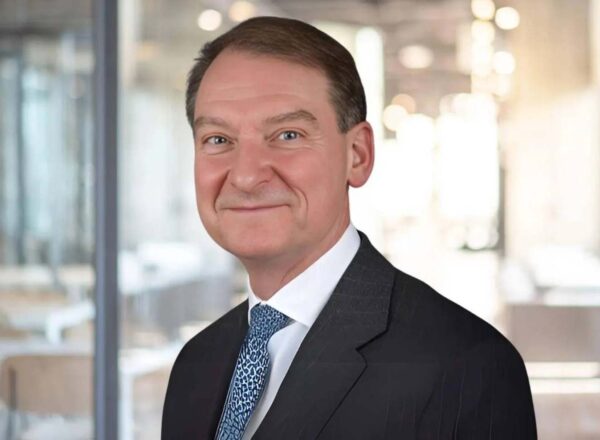 headshot of man in suit and tie