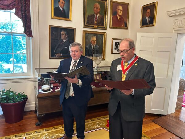 two men in suits reading script
