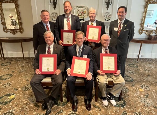 group of men holding certificates