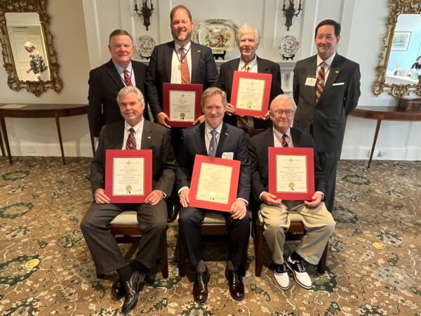 group of men holding certificates