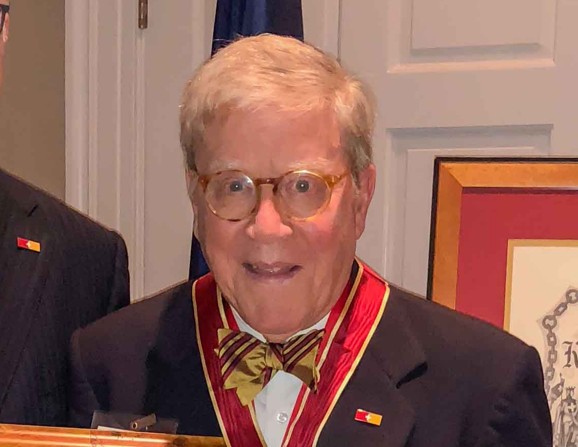 headshot of a man in glasses