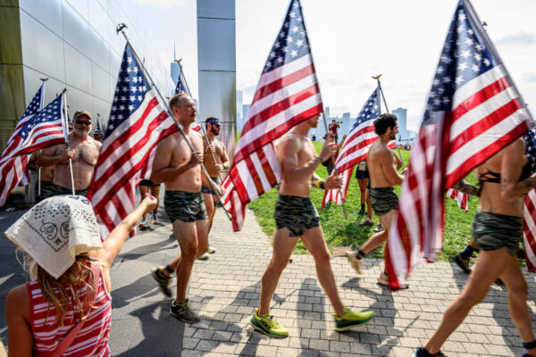 men carrying U.S. flags