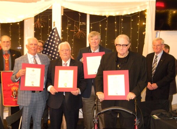 men in suits holding certificates