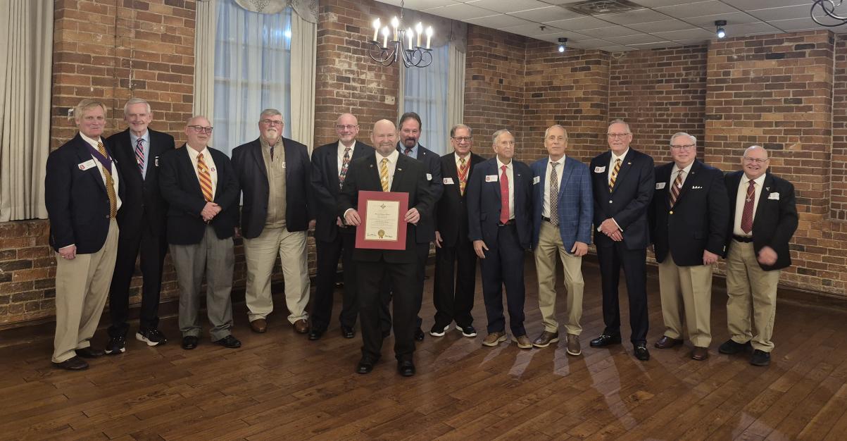 group of men in coat and tie